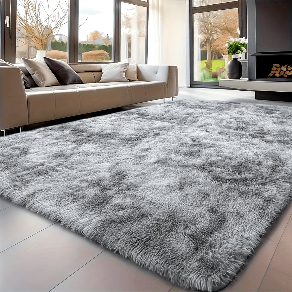 Gray shaggy rug in a living room with a beige sofa and large windows.