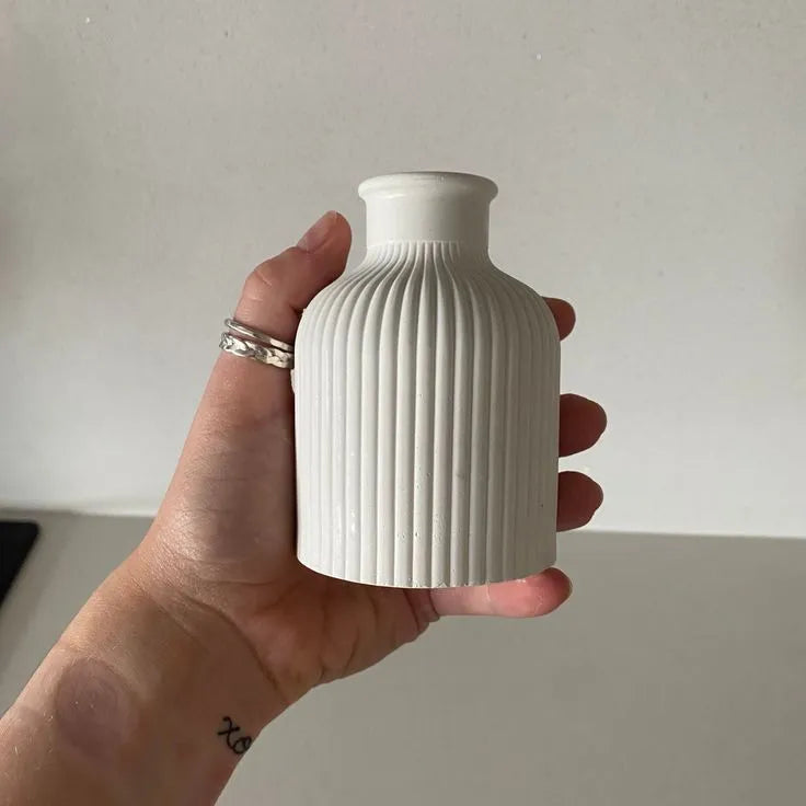 Hand holding a white ribbed vase against a plain background Set of 3 Home Decor – Jewelry Box, Mini Vase & Oval Tray
