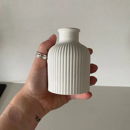 Hand holding a white ribbed vase against a plain background Set of 3 Home Decor – Jewelry Box, Mini Vase & Oval Tray